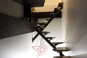 Escalier suspendu en bois et métal au design audacieux, reliant les deux niveaux de la maison.