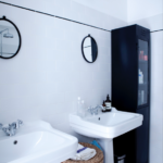 Salle de bain contemporaine avec double vasque, carrelage blanc et colonne noire, dans un loft à vendre rue du Faubourg Saint-Denis à Paris 10ᵉ.