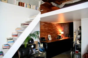 Escalier design et coin bureau en bois, avec détails de décoration personnalisés, dans un esprit galerie d'art et musique.