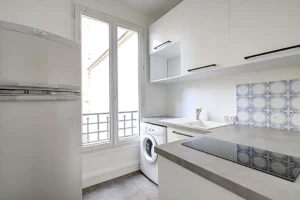 Cuisine indépendante rénovée du studio à vendre Paris 18 Abbesses avec électroménager et carrelage mural décoratif