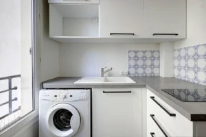 Cuisine équipée du studio à vendre Paris 18 Abbesses avec évier, plaques vitrocéramiques et lave-linge intégré