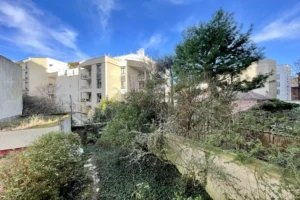 Vue dégagée depuis l’appartement 4 pièces à vendre à Paris 12 Bel Air, donnant sur jardin arboré et immeubles voisins, environnement calme et résidentiel.